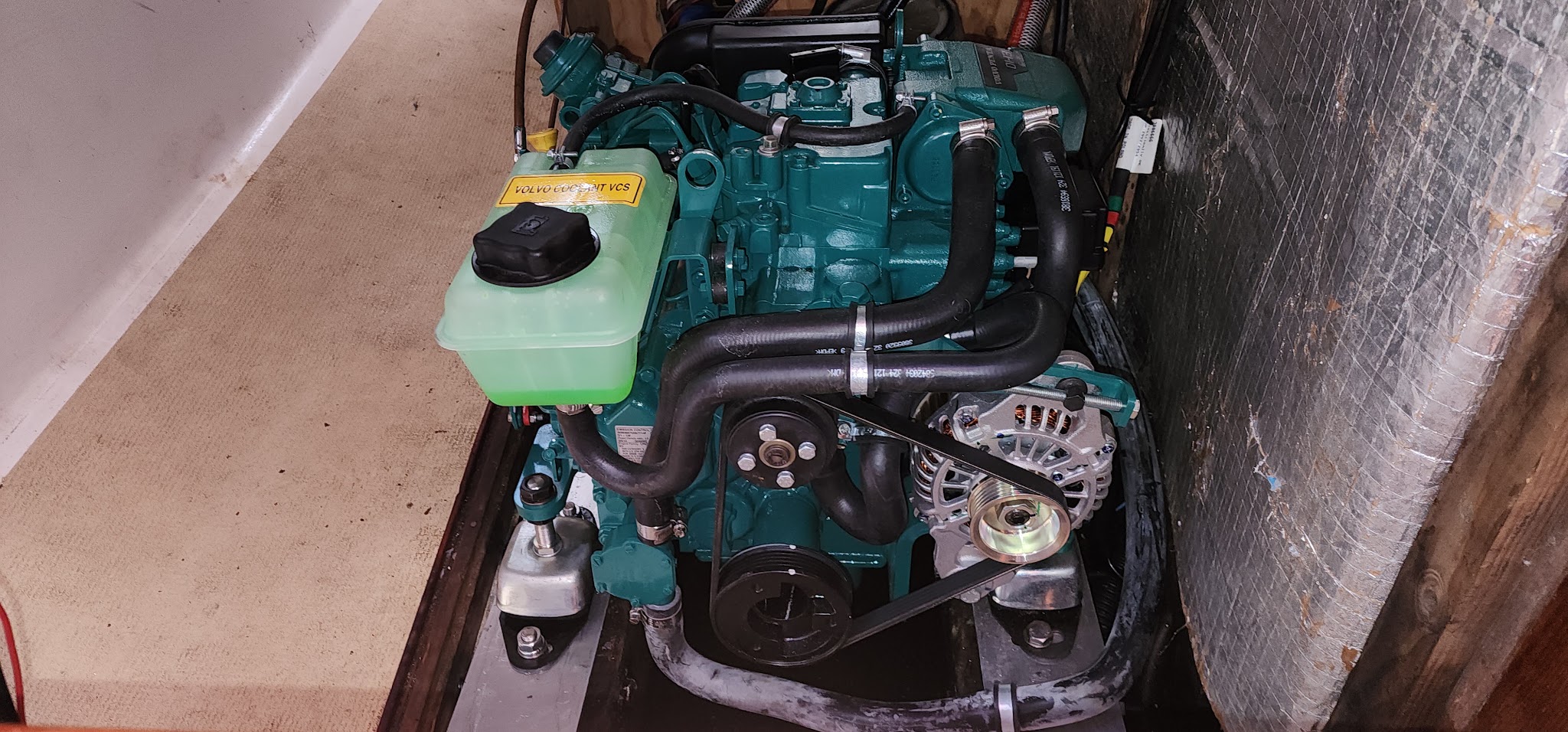 A Volvo Penta inboard sitting in a freshly painted engine bay